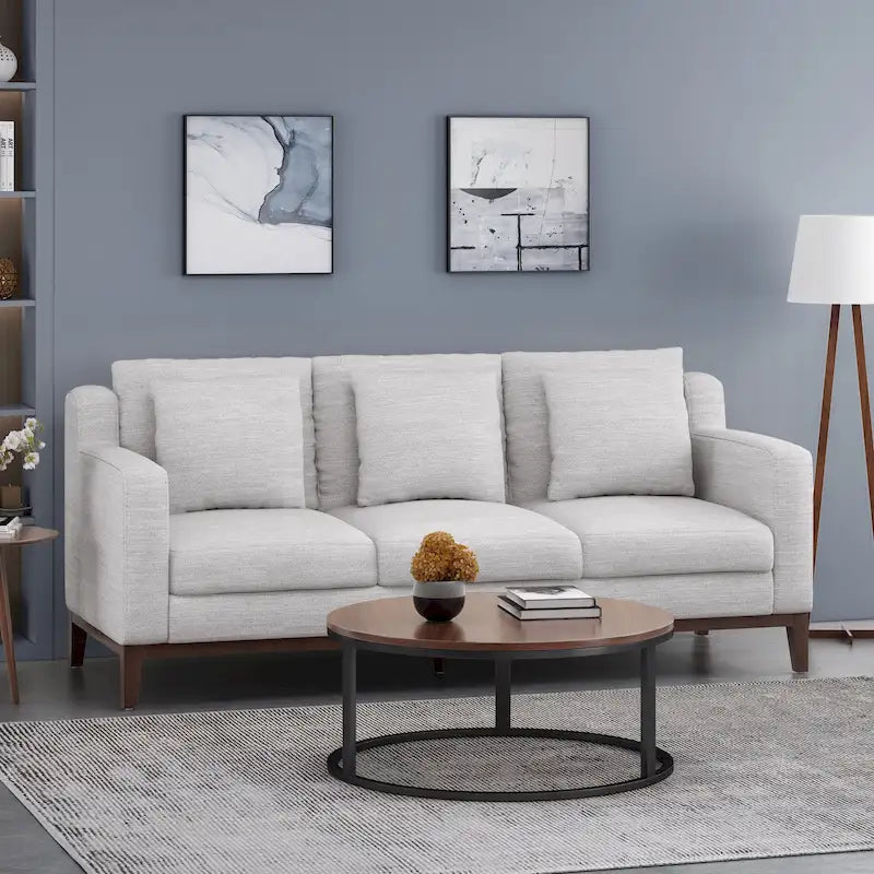 Un canapé trois places moderne avec coussins décoratifs.