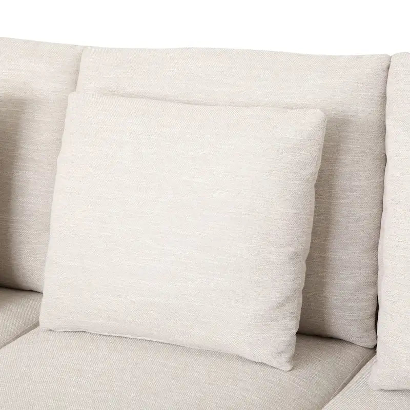 Un canapé trois places moderne avec coussins décoratifs.